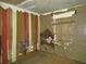 Interior shot of a damaged bedroom with boarded window at 3421 Fudge Rd, Apopka, FL 32712