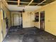 Damaged living room with kitchen access at 3421 Fudge Rd, Apopka, FL 32712