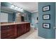 Bathroom with granite countertop, dark wood cabinets and tiled shower at 3799 S Atlantic Ave # 602, Daytona Beach, FL 32118