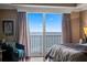 Bedroom with ocean view and sliding glass doors at 3799 S Atlantic Ave # 602, Daytona Beach, FL 32118
