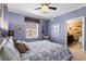 Bedroom with queen bed, ceiling fan, and access to bathroom at 3799 S Atlantic Ave # 602, Daytona Beach, FL 32118