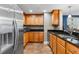 Modern kitchen with wood cabinets, granite counters, and stainless steel appliances at 3799 S Atlantic Ave # 602, Daytona Beach, FL 32118