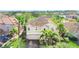 Two-story house with beige exterior and a three-car garage at 3915 Shoreview Dr, Kissimmee, FL 34744