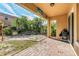Covered patio overlooking a stone patio and backyard landscape at 3915 Shoreview Dr, Kissimmee, FL 34744