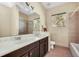 Double vanity bathroom with a shower and bathtub at 3915 Shoreview Dr, Kissimmee, FL 34744