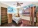 bedroom with hardwood floors, built-in shelves and city mural at 3915 Shoreview Dr, Kissimmee, FL 34744