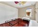 Simple bedroom with wood floors, a bed frame, and a white table at 3915 Shoreview Dr, Kissimmee, FL 34744