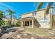 Two-story house with a tropical mural, patio, and landscaped yard at 3915 Shoreview Dr, Kissimmee, FL 34744