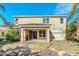 Two-story house exterior with a tropical mural and stone patio at 3915 Shoreview Dr, Kissimmee, FL 34744