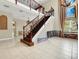 Elegant wooden staircase with wrought iron railings at 3915 Shoreview Dr, Kissimmee, FL 34744