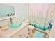 Bathroom with light teal decor and glass sink at 4153 S Atlantic Ave # 1020, New Smyrna Beach, FL 32169
