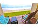 Beachfront balcony with rocking chairs, offering stunning ocean views at 4153 S Atlantic Ave # 1020, New Smyrna Beach, FL 32169