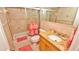 Bathroom with tub and granite vanity at 4153 S Atlantic Ave # 1030, New Smyrna Beach, FL 32169