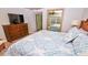 King size bed, dresser, and ocean view from bedroom mirror at 4153 S Atlantic Ave # 1030, New Smyrna Beach, FL 32169