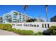 Sea Coast Gardens III building exterior with palm trees and signage at 4153 S Atlantic Ave # 1030, New Smyrna Beach, FL 32169