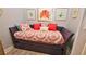 Cozy daybed with coral-themed bedding and artwork at 4153 S Atlantic Ave # 1030, New Smyrna Beach, FL 32169