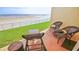 Private patio overlooking the beach with lounge chairs and seating at 4153 S Atlantic Ave # 1030, New Smyrna Beach, FL 32169