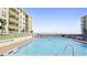 Refreshing swimming pool with ample lounge space at 4153 S Atlantic Ave # 1030, New Smyrna Beach, FL 32169