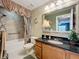 Bathroom with granite vanity, tiled shower, and decorative curtain at 4208 Clubside Dr # 4208, Longwood, FL 32779
