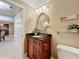 Charming powder room with decorative mirror, granite countertop, and elegant fixtures at 4208 Clubside Dr # 4208, Longwood, FL 32779
