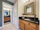Bathroom featuring wood cabinets with a dark countertop and a connecting bathroom at 4208 Clubside Dr # 4208, Longwood, FL 32779