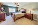 Bright bedroom with king-size bed and wood furniture at 4208 Clubside Dr # 4208, Longwood, FL 32779