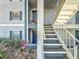 Condo building exterior with stairs leading to upper-level units and well-maintained landscaping at 4208 Clubside Dr # 4208, Longwood, FL 32779