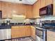 Updated kitchen features stainless appliances, dark countertops and light wood cabinets for a stylish touch at 4208 Clubside Dr # 4208, Longwood, FL 32779