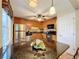 Kitchen island with granite countertops, light wood cabinets, and stainless-steel appliances at 4208 Clubside Dr # 4208, Longwood, FL 32779