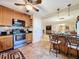 Kitchen with stainless-steel appliances, and a ceiling fan above the island and bar seating at 4208 Clubside Dr # 4208, Longwood, FL 32779