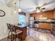 Kitchen with granite counters, stainless appliances, breakfast bar with pendant lights, and tile floors at 4208 Clubside Dr # 4208, Longwood, FL 32779