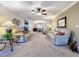 Comfortable living room with plush sofas, ceiling fan, and an open layout into the dining area at 4208 Clubside Dr # 4208, Longwood, FL 32779