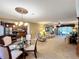 Open-concept living area with plush carpet, comfortable seating, and an adjacent kitchen and dining area at 4208 Clubside Dr # 4208, Longwood, FL 32779