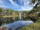 Serene pond with water fountain, lush trees at 4208 Clubside Dr # 4208, Longwood, FL 32779