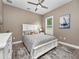 Cozy bedroom with a queen-size bed and calming decor at 421 Nowell Loop, Deland, FL 32724