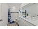 Modern bathroom with double vanity, subway tile shower, and wood-look flooring at 4386 Sw 169Th Lane Rd, Ocala, FL 34473