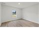 Simple bedroom with wood-look floors and a large window at 4386 Sw 169Th Lane Rd, Ocala, FL 34473