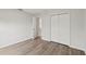 Simple bedroom with wood-look floors and a double door closet at 4386 Sw 169Th Lane Rd, Ocala, FL 34473