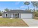 Newly constructed home with gray siding, attached garage, and well-manicured lawn at 4386 Sw 169Th Lane Rd, Ocala, FL 34473