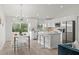 Modern white kitchen with stainless steel appliances and breakfast bar at 4386 Sw 169Th Lane Rd, Ocala, FL 34473