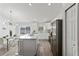 Modern white kitchen with stainless steel appliances and large island at 4386 Sw 169Th Lane Rd, Ocala, FL 34473