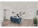 Bright living room with teal sofas, wood-look floors, and ample natural light at 4386 Sw 169Th Lane Rd, Ocala, FL 34473
