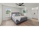 Spacious bedroom with gray upholstered bed and plenty of natural light at 4386 Sw 169Th Lane Rd, Ocala, FL 34473