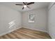 Simple bedroom with hardwood floors, a ceiling fan, and a closet at 4530 N Hiawassee Rd, Orlando, FL 32818