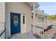 Newly renovated home's blue front door with sidelights and a deck at 4530 N Hiawassee Rd, Orlando, FL 32818