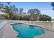 Inviting kidney-shaped pool with white fence and water features at 4530 N Hiawassee Rd, Orlando, FL 32818