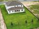 Aerial view of a two-story home with a large backyard and a patio at 5067 Northern Dove Ave, Mount Dora, FL 32757