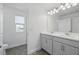Bathroom featuring a double sink vanity with modern fixtures, and a shower at 5067 Northern Dove Ave, Mount Dora, FL 32757