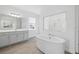 Bathroom featuring double vanity, soaking tub, and glass enclosed shower at 5067 Northern Dove Ave, Mount Dora, FL 32757