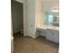 Elegant bathroom with double vanity and a separate toilet room at 5067 Northern Dove Ave, Mount Dora, FL 32757